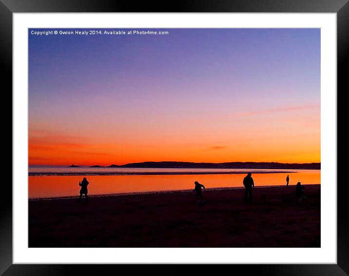 Playing on the beach at sundown Framed Mounted Print by Gwion Healy