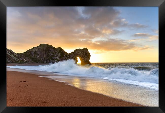 Sunrise through the arch of Durdle Door  Framed Print by Shaun Jacobs