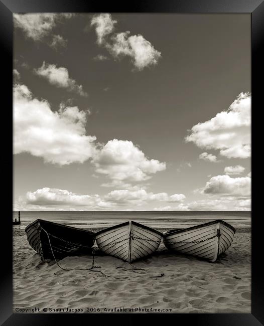 Fishing boats on a beach Framed Print by Shaun Jacobs