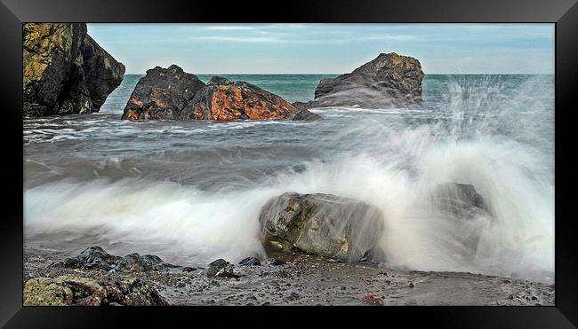 Waves against the rocks Framed Print by Derek Dobbie