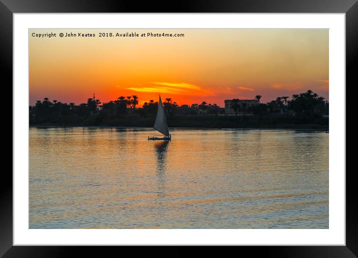 Sunset on the Nile River with Felucca boat sailing Framed Mounted Print by John Keates
