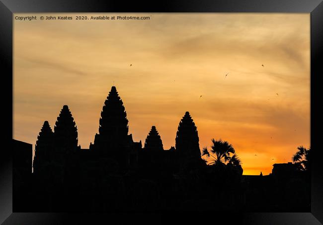 Sun rise at the Angkor Wat temple, Cambodia Framed Print by John Keates