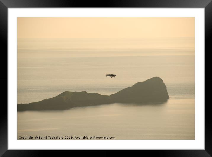 Small plane over Worm's Head, Rhossili, Gower, UK Framed Mounted Print by Bernd Tschakert