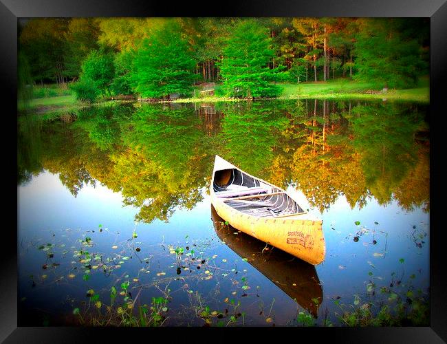 canoe  on the water Framed Print by Daniel Kesh