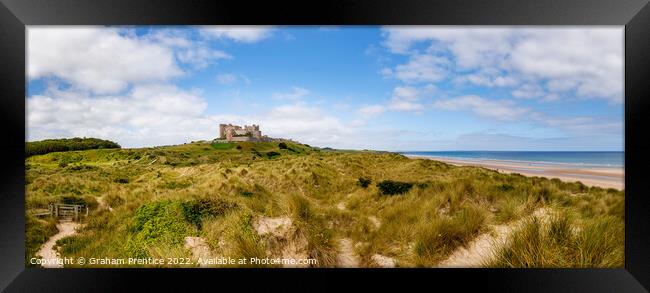 Bamburgh Castle over Sand Dunes Framed Print by Graham Prentice