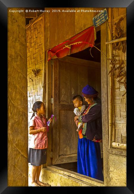 Family life in a Laotion village Framed Print by Robert Murray