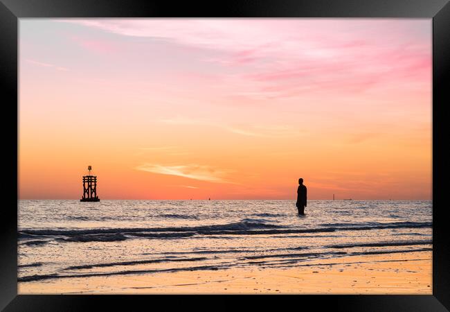 Silhouettes of an Iron Man and a tide marker Framed Print by Jason Wells