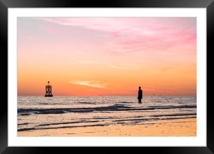 Silhouettes of an Iron Man and a tide marker Framed Mounted Print by Jason Wells
