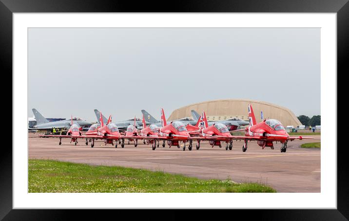 The Red Arrows hug a taxiway in front of four Typhoon's Framed Mounted Print by Jason Wells