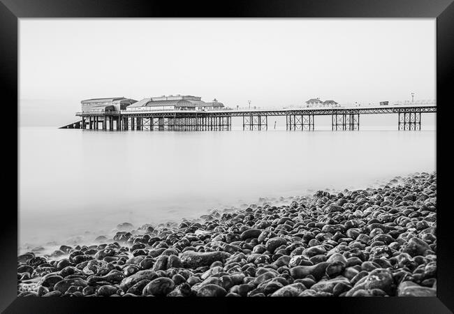 Cromer pier seen over the pebble beach in monochro Framed Print by Jason Wells