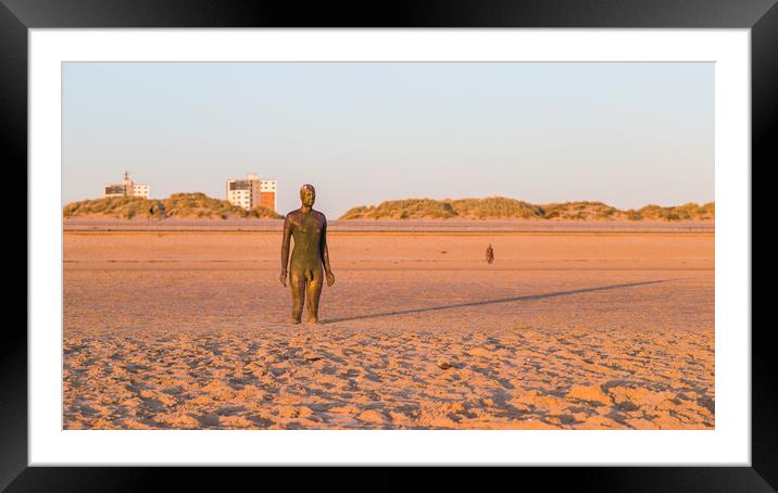 Long shadow behind an Iron Man at sunset Framed Mounted Print by Jason Wells