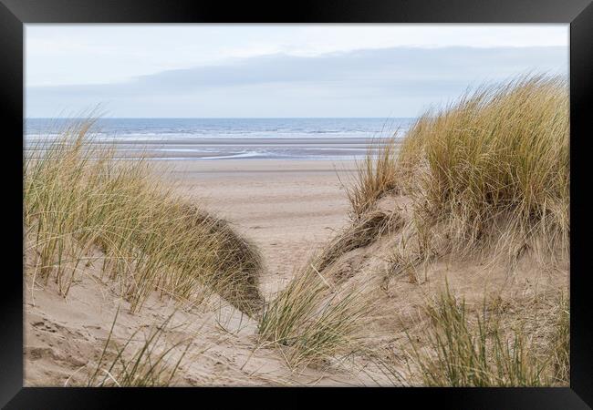 Irish Sea between the sand dunes Framed Print by Jason Wells