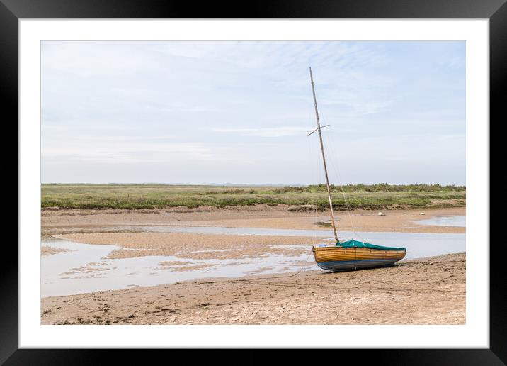 Sailing boat beached at low tide at Blakeney Framed Mounted Print by Jason Wells