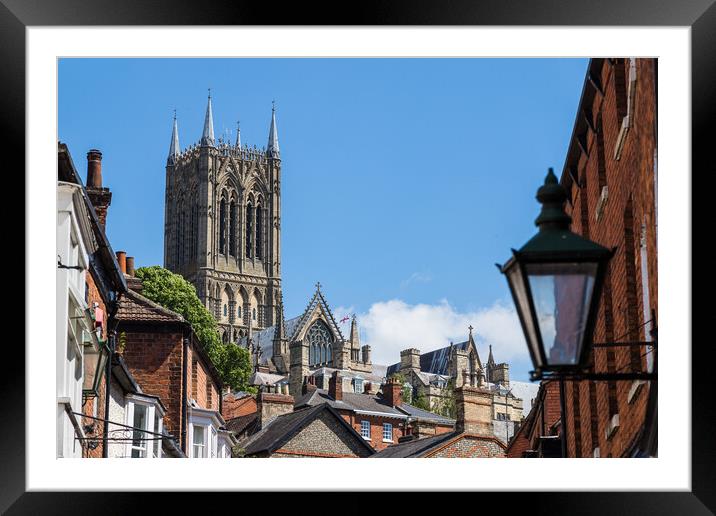 Lincoln cathedral peaking above the rooftops of the city Framed Mounted Print by Jason Wells