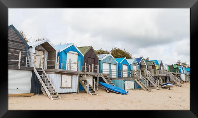 Abersoch beach huts lined up Framed Print by Jason Wells