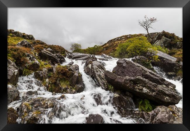 Water crashes over rocks at Ogwen Valley Framed Print by Jason Wells