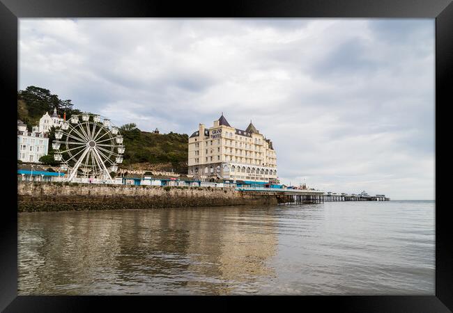 Llandudno Pier reflecting in the water Framed Print by Jason Wells