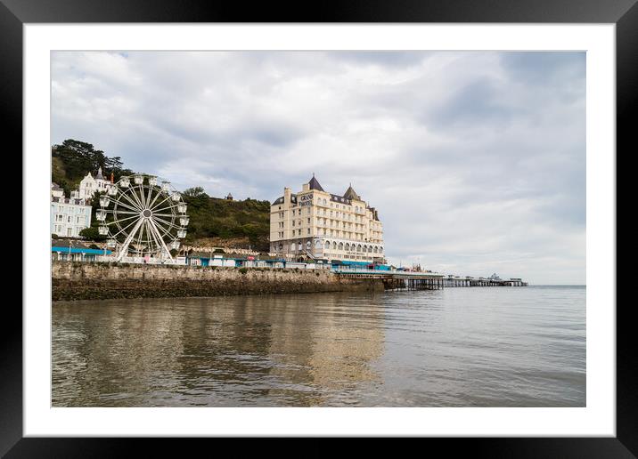 Llandudno Pier reflecting in the water Framed Mounted Print by Jason Wells