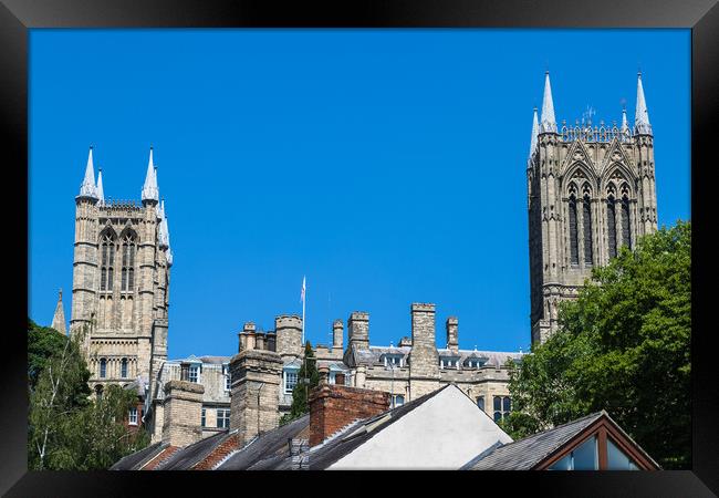 Lincoln cathedral peaks above the city skyline Framed Print by Jason Wells