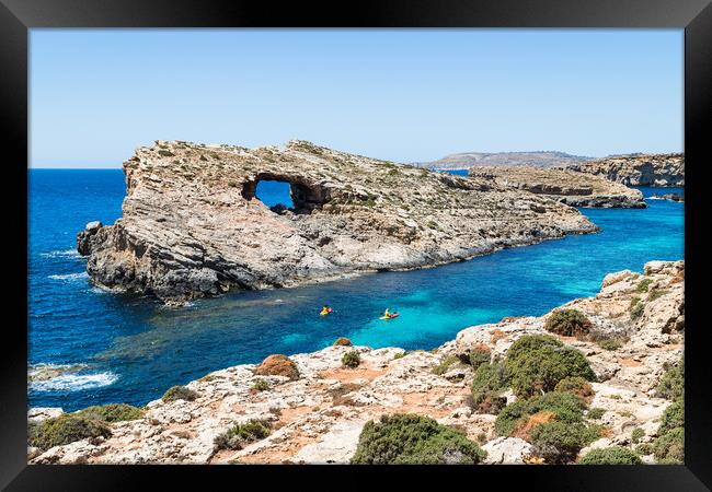 Tourists kayaking into the Blue Lagoon Framed Print by Jason Wells