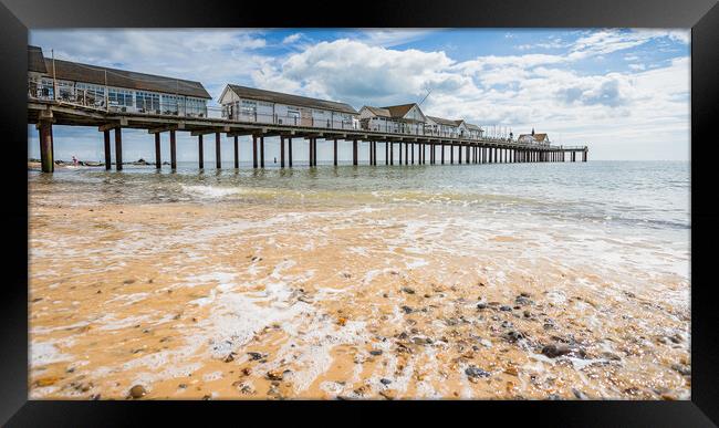 Waves wash back into the sea under Southwold Pier Framed Print by Jason Wells