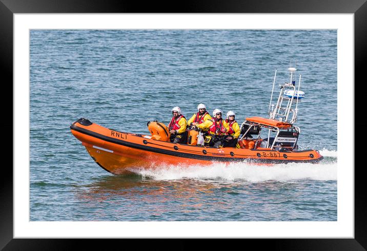 RNLI Life boat racing into the sea Framed Mounted Print by Jason Wells