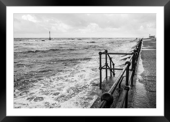 Waves breaking onto the promenade at Crosby Framed Mounted Print by Jason Wells