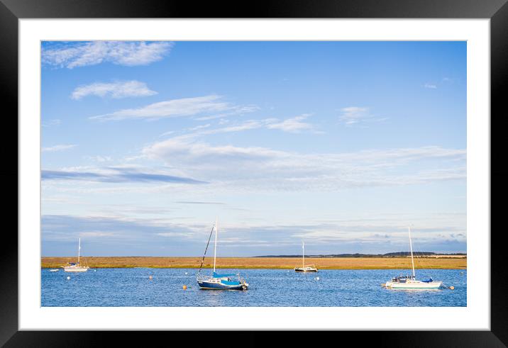 Boats lit up at high tide Framed Mounted Print by Jason Wells
