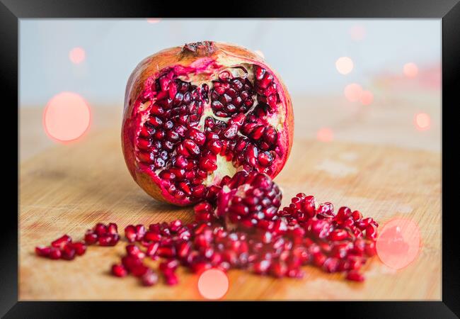 Pomegranate seeds amongst red lights Framed Print by Jason Wells