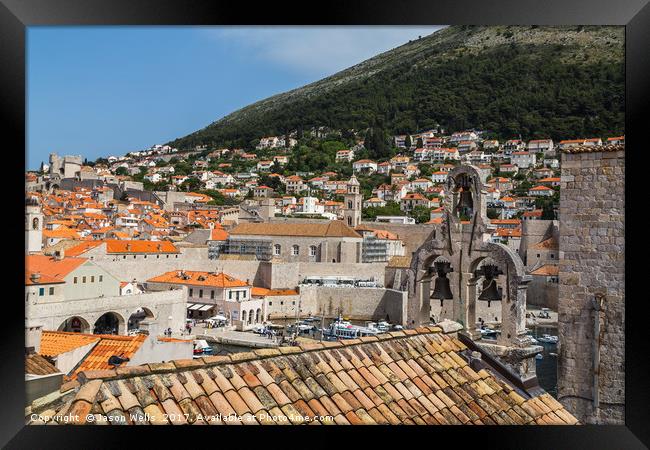 Overlooking the bells on a church towards the old  Framed Print by Jason Wells