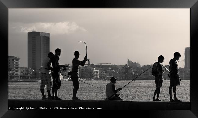 Men fishing from the Malecon wall at dusk Framed Print by Jason Wells