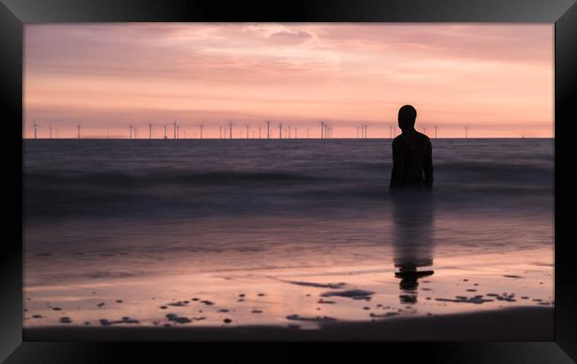 Iron Man watches out to sea at dusk Framed Print by Jason Wells