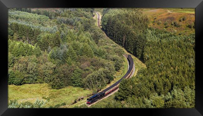 Steam train navigating a valley Framed Print by Jason Wells