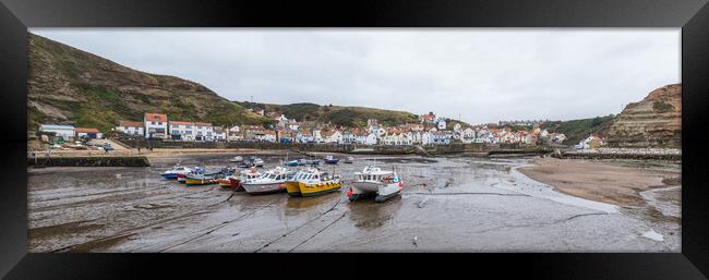 Boats lined up in the bay at Staithes at low tide Framed Print by Jason Wells