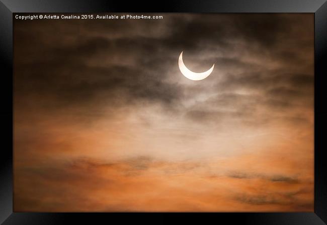 Partial solar eclipse and clouds morning sky  Framed Print by Arletta Cwalina
