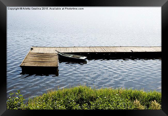 boat moored to old cracked wood bridge  Framed Print by Arletta Cwalina