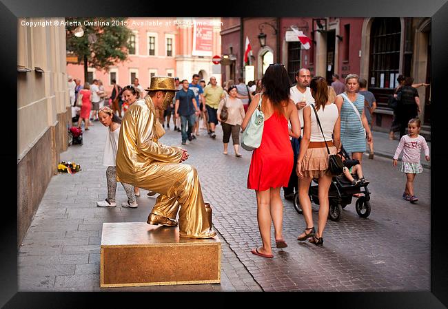 Levitating golden dressed man Framed Print by Arletta Cwalina