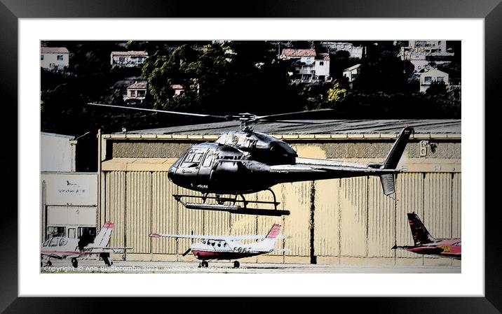 Helicopter hovering  Framed Mounted Print by Ann Biddlecombe