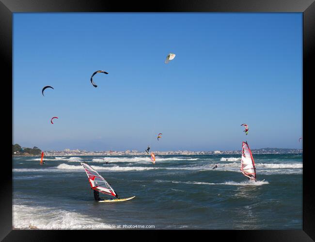 windsurfers and kite surfers on Palm beach Framed Print by Ann Biddlecombe
