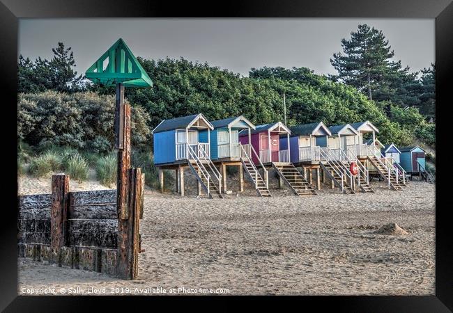 Beach huts and marker at Wells next the Sea, Norfo Framed Print by Sally Lloyd