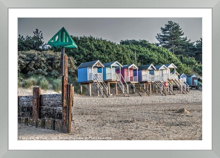 Beach huts and marker at Wells next the Sea, Norfo Framed Mounted Print by Sally Lloyd