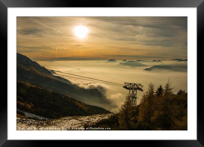 The sun sets over a sea of clouds Framed Mounted Print by Fabrizio Malisan