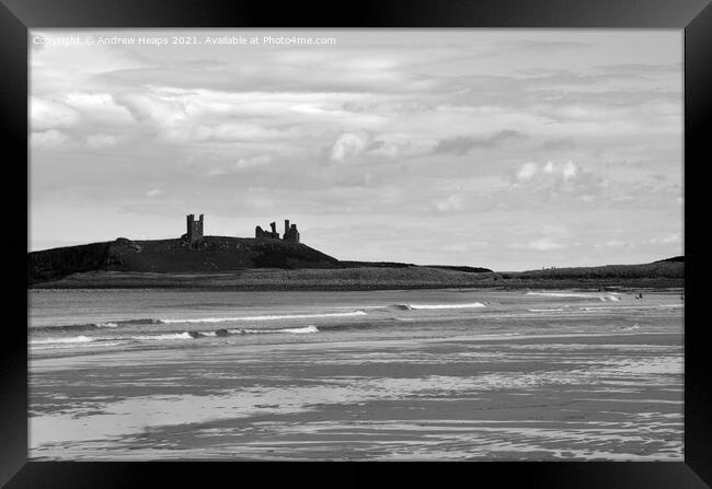 Dunstanburgh castle with waves viewed from beach. Framed Print by Andrew Heaps