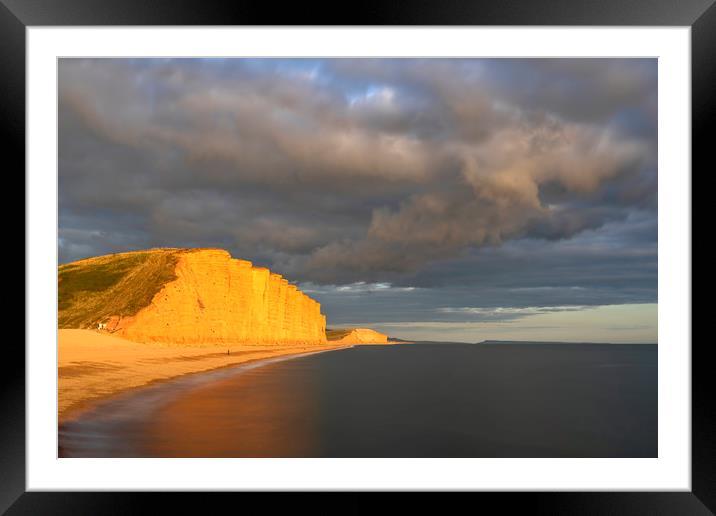 Storm clouds over East Cliff (West Bay) Framed Mounted Print by Andrew Ray