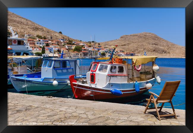 Halki Boats and Chair Framed Print by Rick Bowden