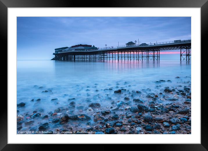Pebbles and Pier Framed Mounted Print by Rick Bowden