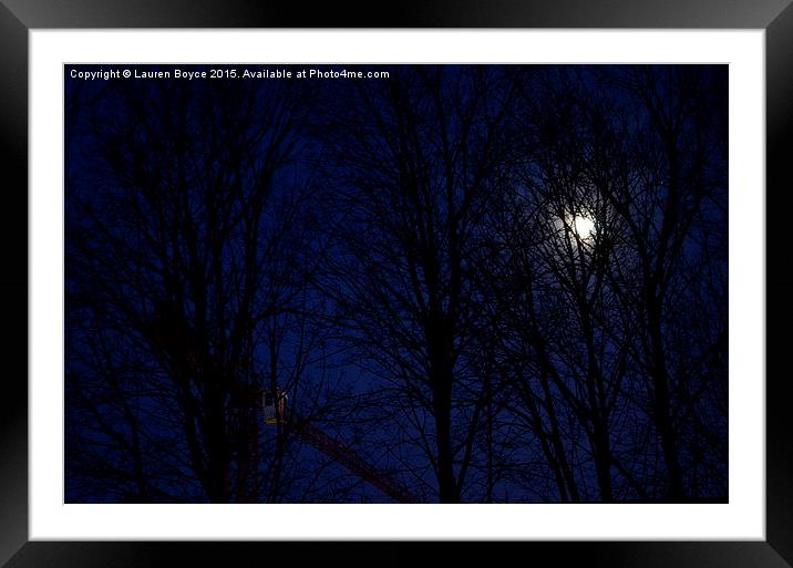 The moon and a crane, at night, through the trees. Framed Mounted Print by Lauren Boyce