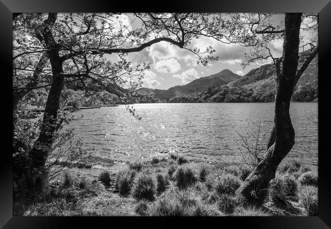 Llyn Gwynant with sunlight sparkling on the water. Snowdonia, North Wales. Framed Print by Andrew Kearton