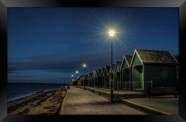 Beach Huts at Gurnard bay at dusk Framed Print by David Oxtaby  ARPS