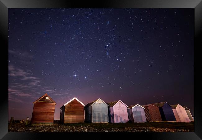 Orion over beach huts Framed Print by Chris Nesbit